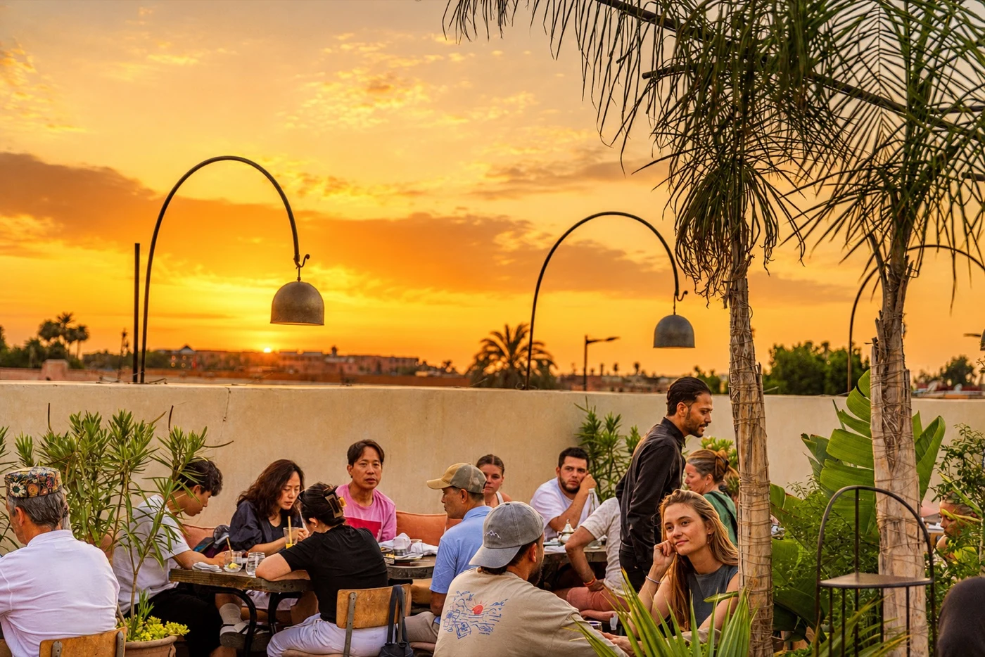 Coco Rooftop terrace glowing at sunset over the Marrakech Medina