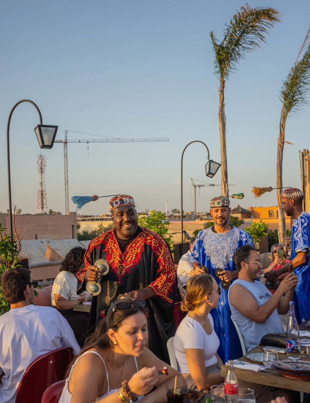 Guests in traditional dress enjoying the sunset terrace