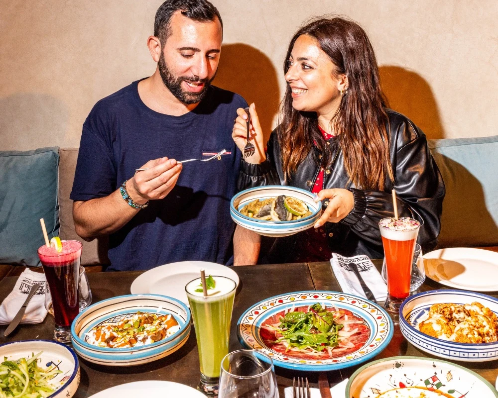 Guests sharing colourful plates at Coco Rooftop