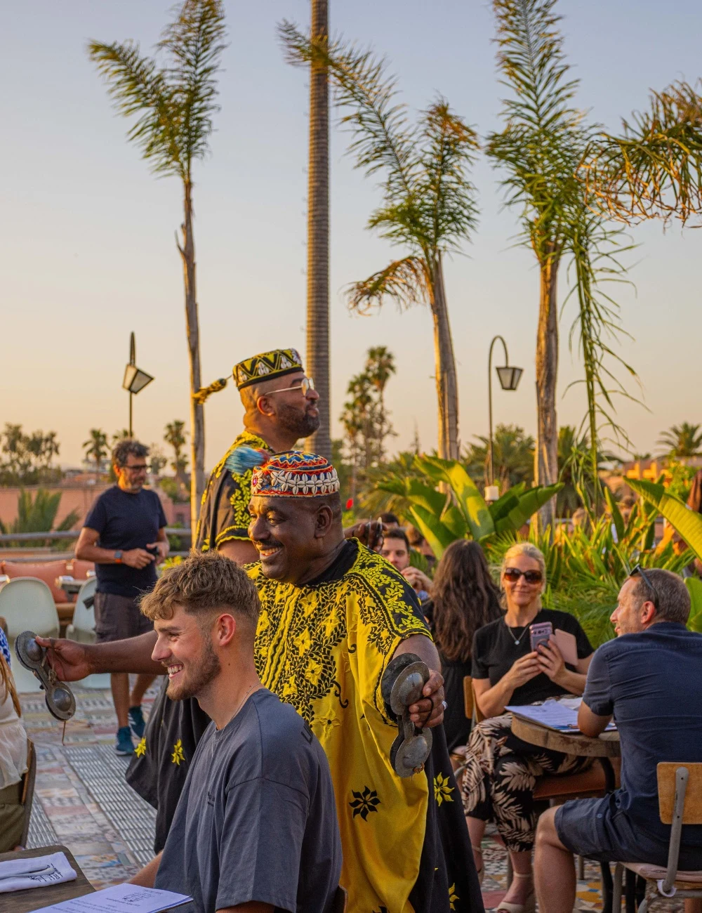 Performer and guests at golden hour on the rooftop