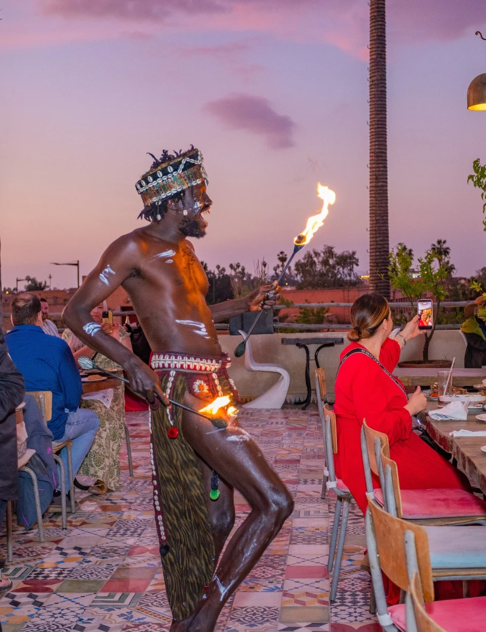 Fire dancer performing at sunset