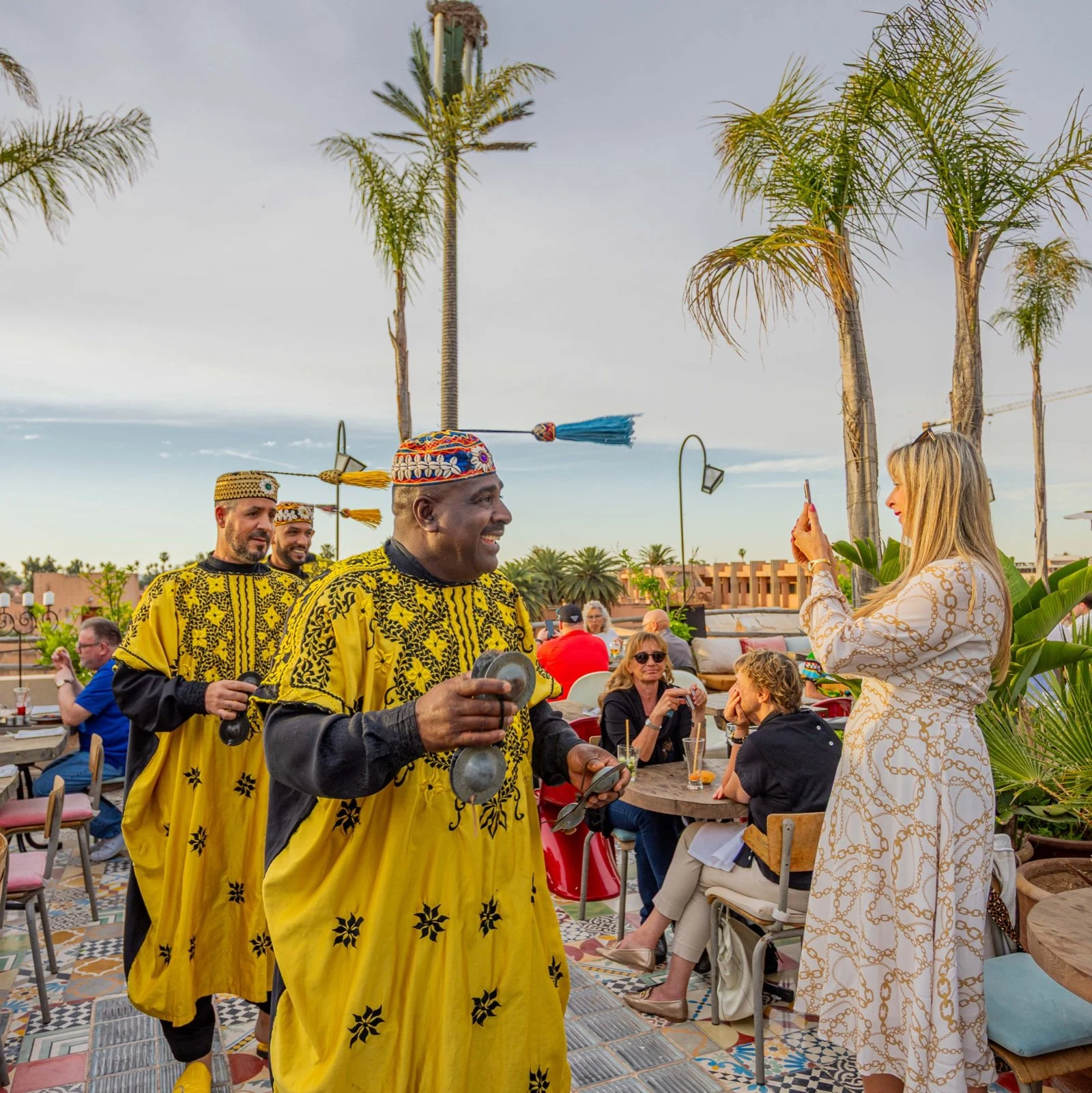 Gnawa musicians performing live among guests at Coco Rooftop