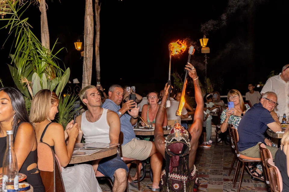 Guests watching a fire performance during dinner at Coco Rooftop