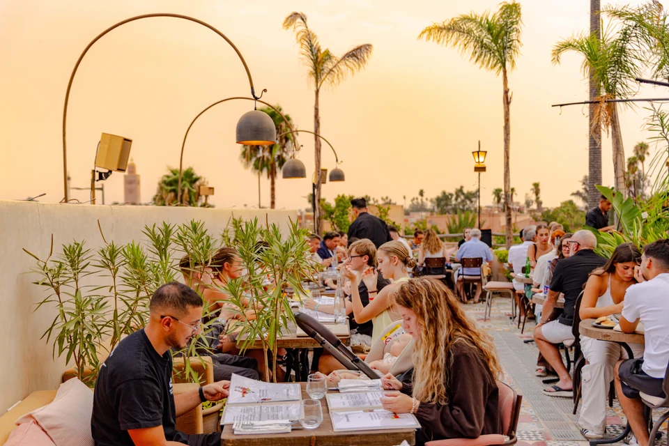 Guests browsing the menu and dining on the Coco Rooftop terrace